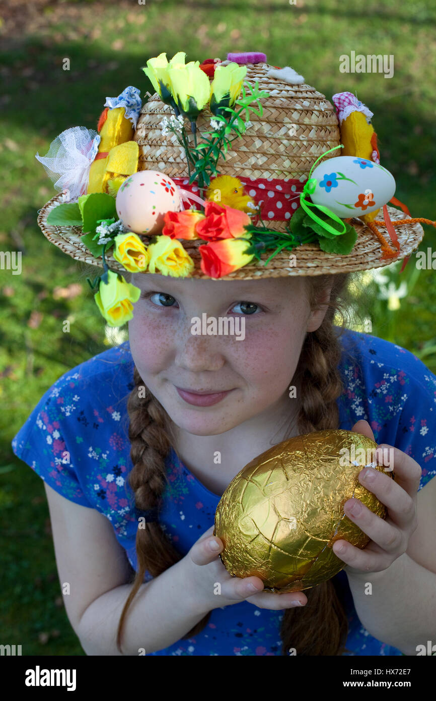 Girl with Easter bonnet on an Easter egg hunt in Lancashire, UK Stock Photo