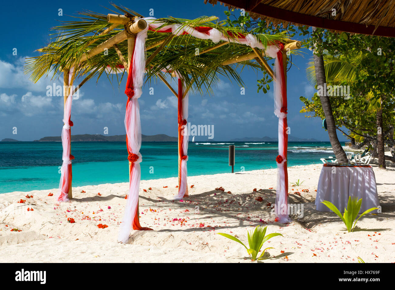 Colourful Beach Wedding Location View: Turquoise Caribbean Ocean and Mayreau. Palm Island, Saint Vincent and the Grenadines. Stock Photo