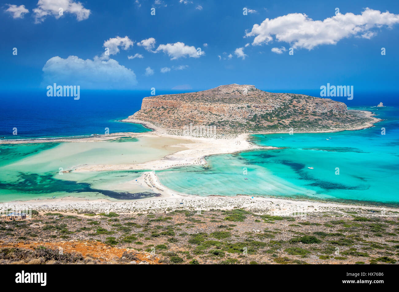 Balos lagoon on Crete island, Greece. Tourists relax and bath in crystal clear water of Balos beach. Stock Photo