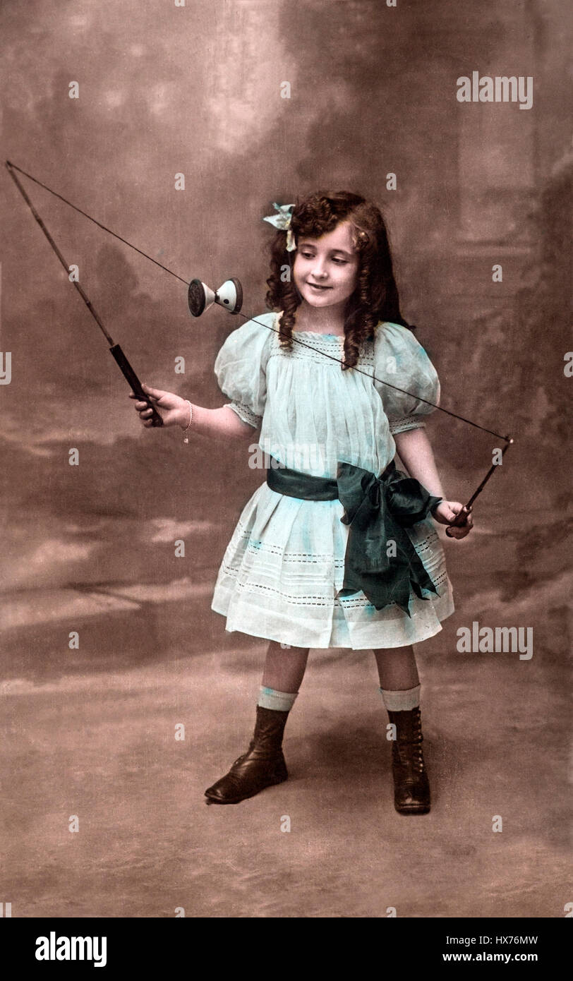 Vintage photo of a young Victorian girl playing a string game, circa 1880s. Stock Photo