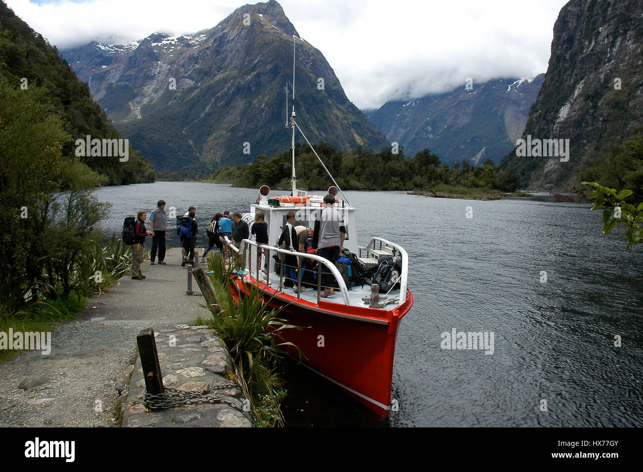 A boat pick up tourists in the Milford Sound. Stock Photo