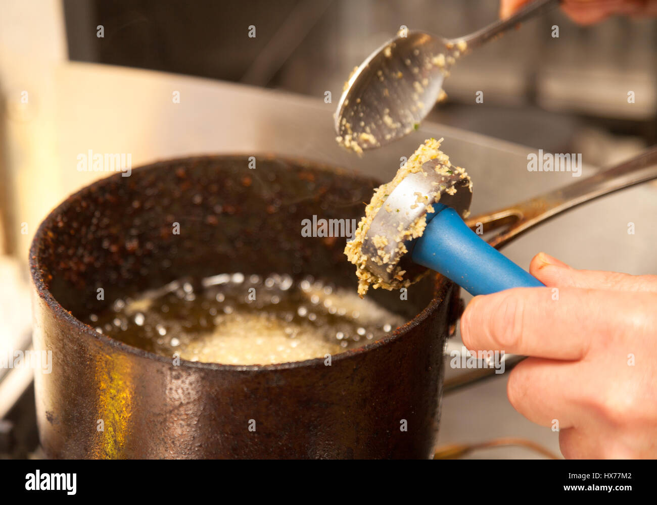 Falafel - cooking falafel to make falafel fritters - example of vegetarian food and vegan food, UK Stock Photo