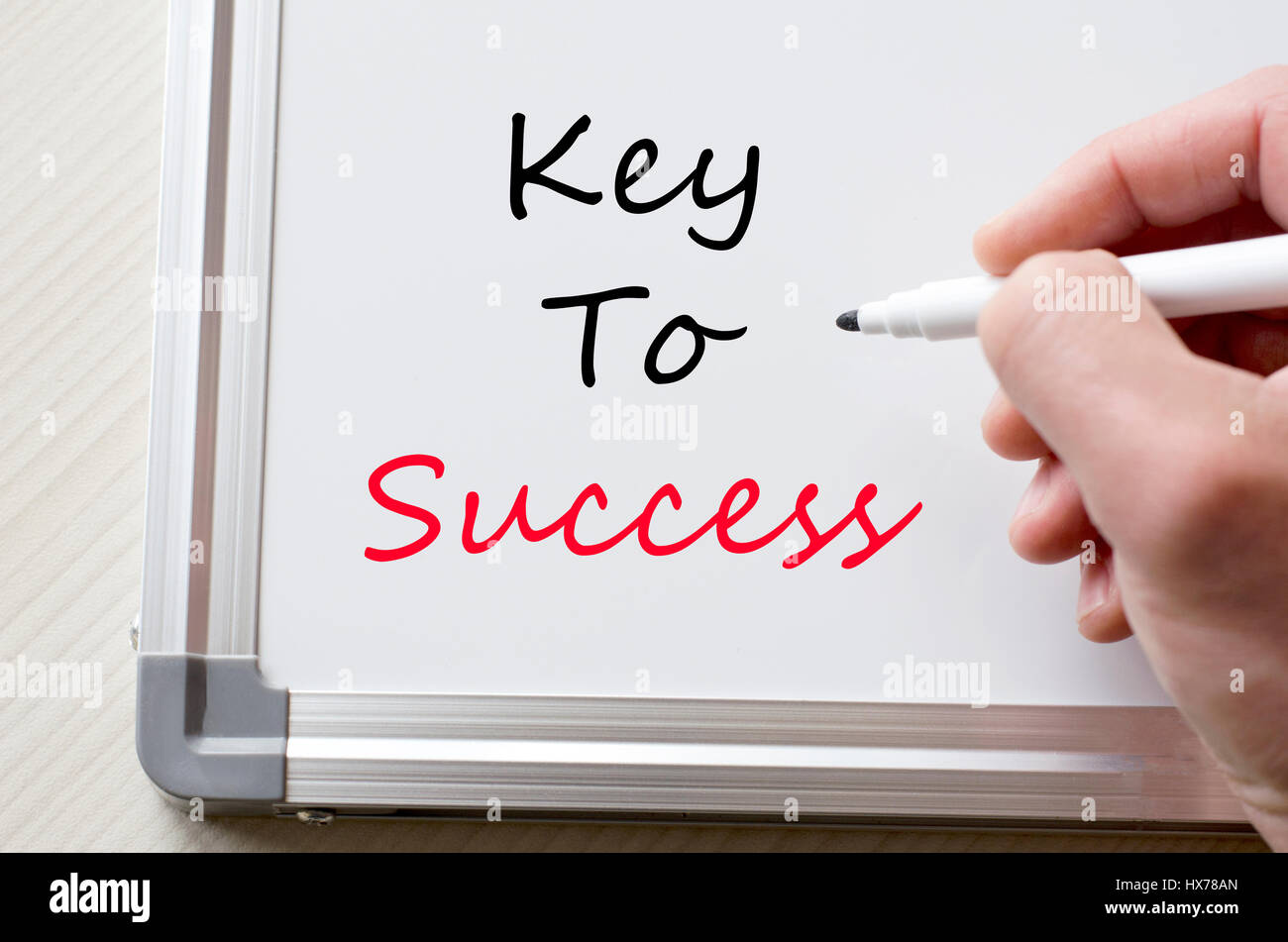 Human hand writing key to success on whiteboard Stock Photo