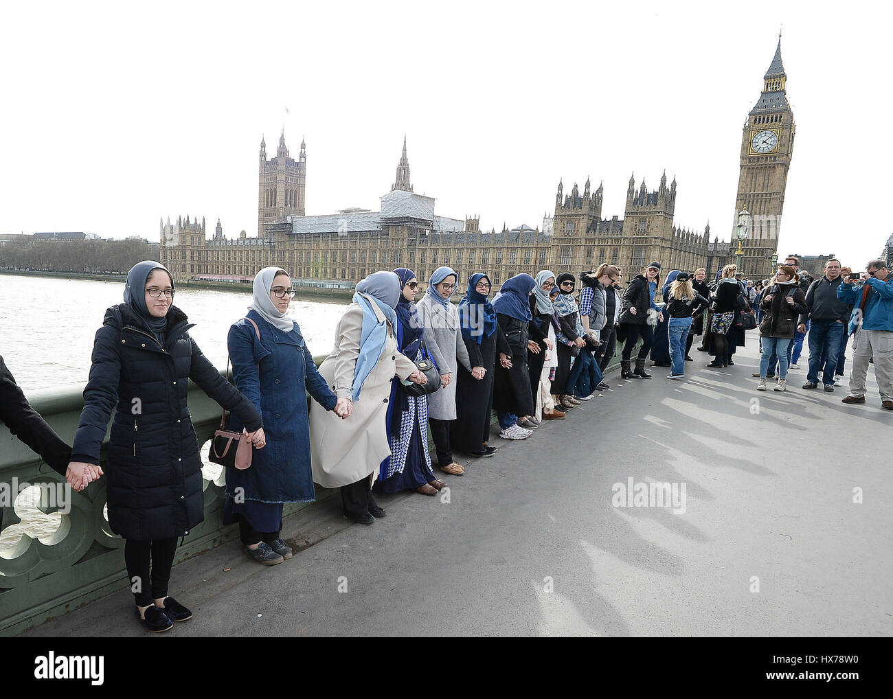 A group of women, some with their daughters, link hands on Westminster bridge in central London in an act of solidarity organised by Women's March London to pay tribute to the victims of the Westminster terrorist attack. Stock Photo