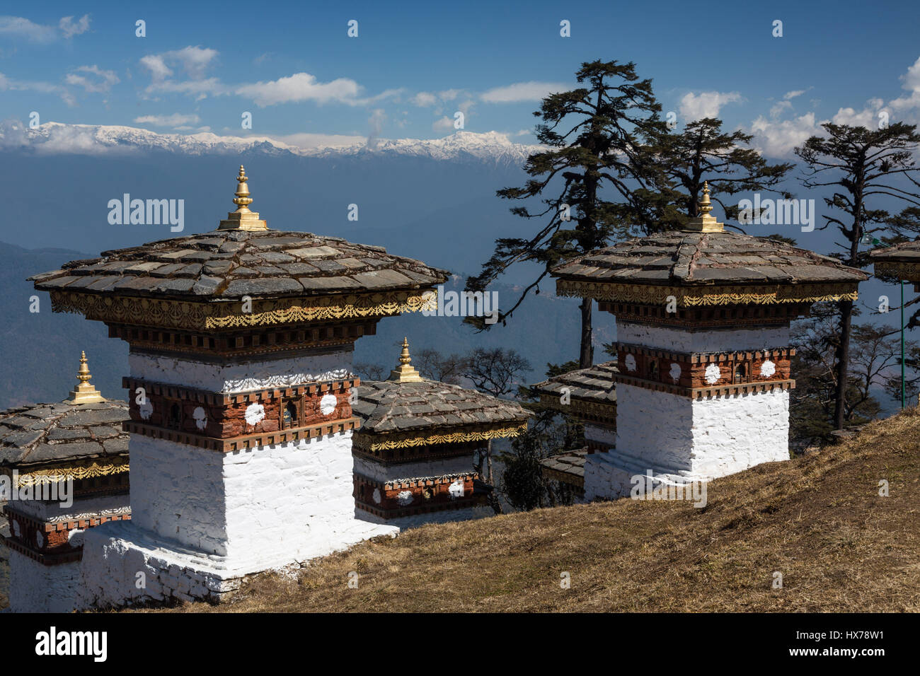 The 108 Druk Wangyal Khang Zhang Chortens, or stupas, are a sacred Bhuddist memorial.  They are red-band or khangzang chortens and are located on a hi Stock Photo