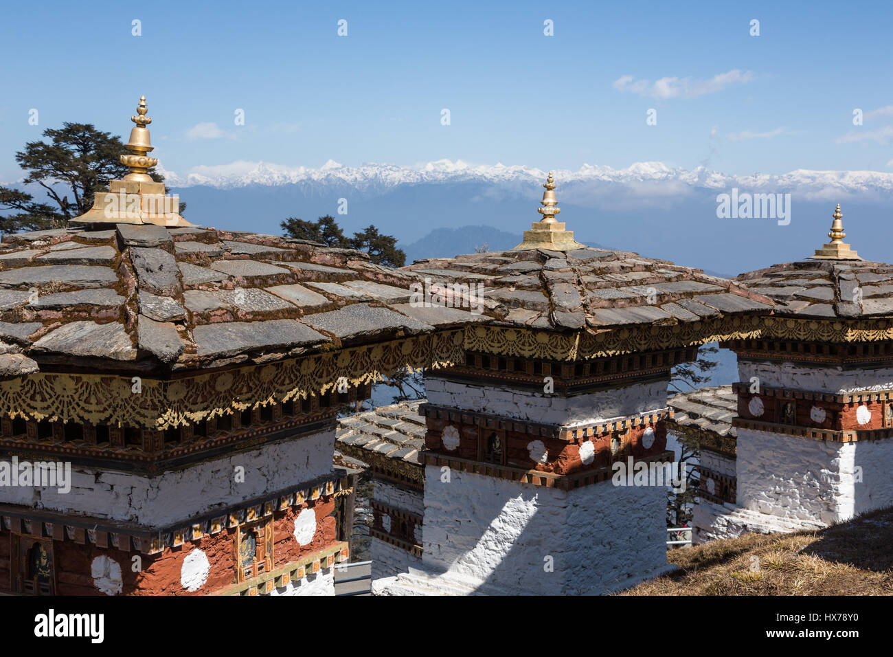 The 108 Druk Wangyal Khang Zhang Chortens, or stupas, are a sacred Bhuddist memorial.  They are red-band or khangzang chortens and are located on a hi Stock Photo