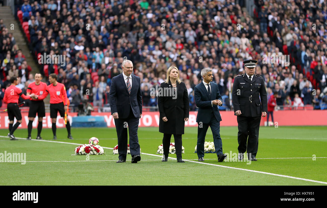 FA Chairman Greg Clarke (left), Secretary of State for Culture, Media and Sport Karen Bradley (second left), The Mayor of London Sadiq Khan (second right) and Acting Metropolitan Police Commissioner Craig Mackey (right) lay wreaths to remember the victims of the Westminster attacks during the World Cup Qualifying match at Wembley Stadium, London. Stock Photo