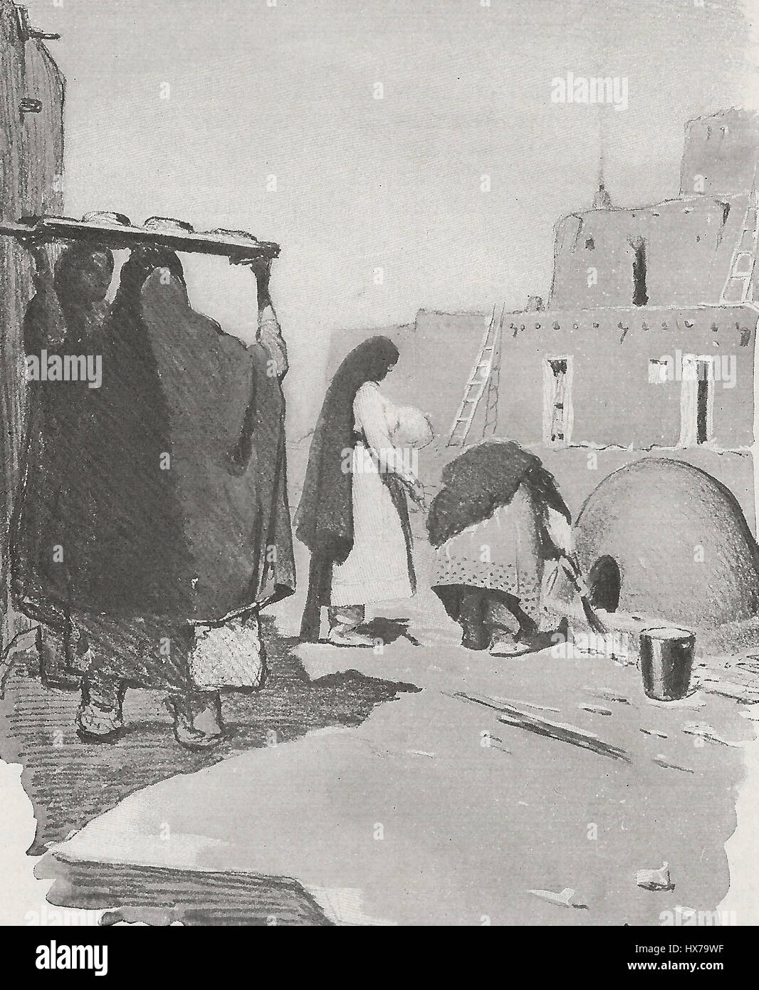 Women baking in outdoor ovens - New Mexico, circa 1916 Stock Photo