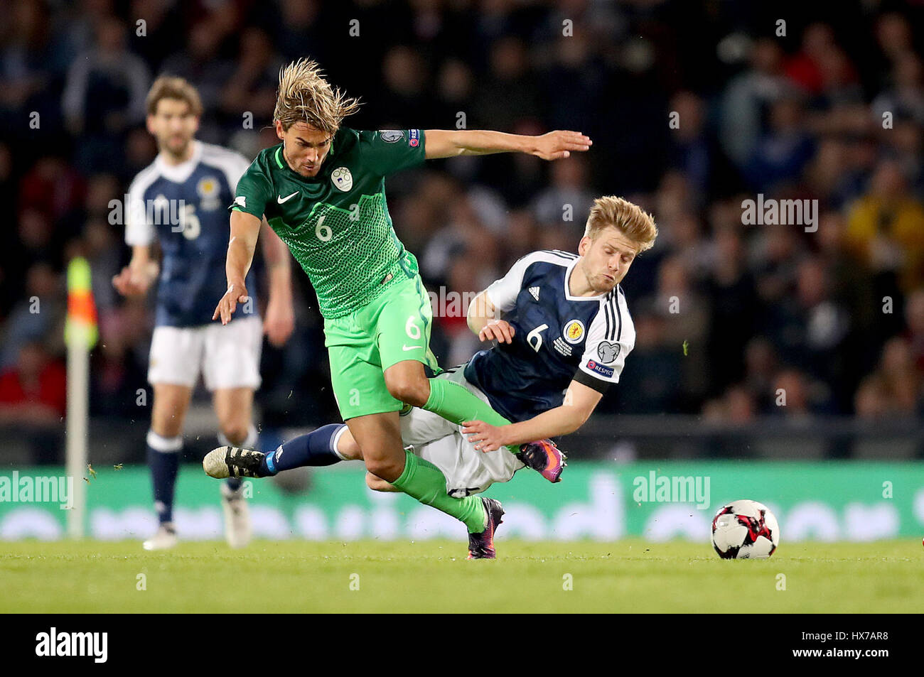 Slovenia's Rene Krhin (left) and Scotland's Stuart Armstrong (right) battle for the ball during the World Cup Qualifying match at Hampden Park, Glasgow. Stock Photo