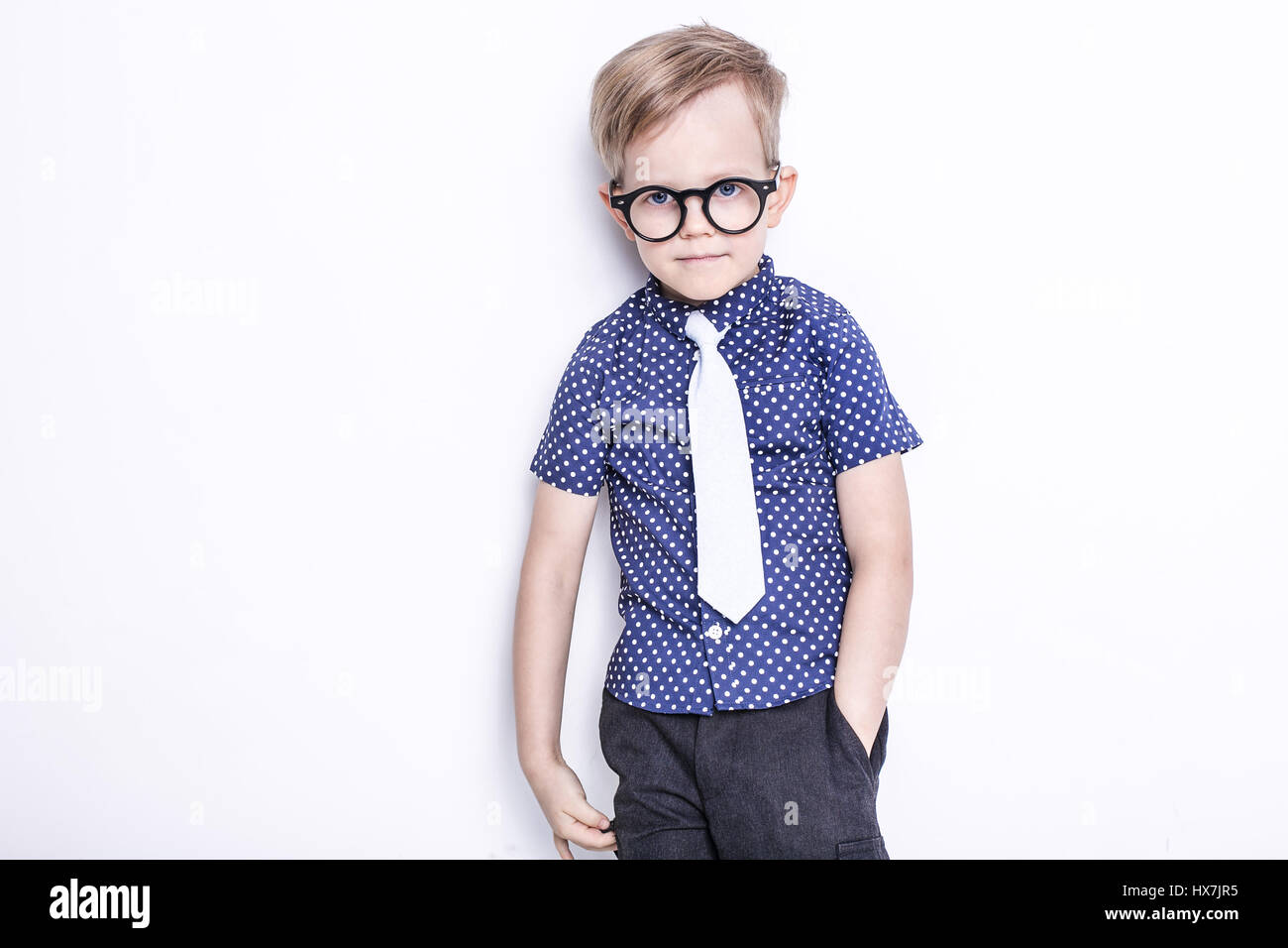 Portrait of a little boy in a funny glasses and tie. School. Preschool. Fashion. Studio portrait isolated over white background Stock Photo