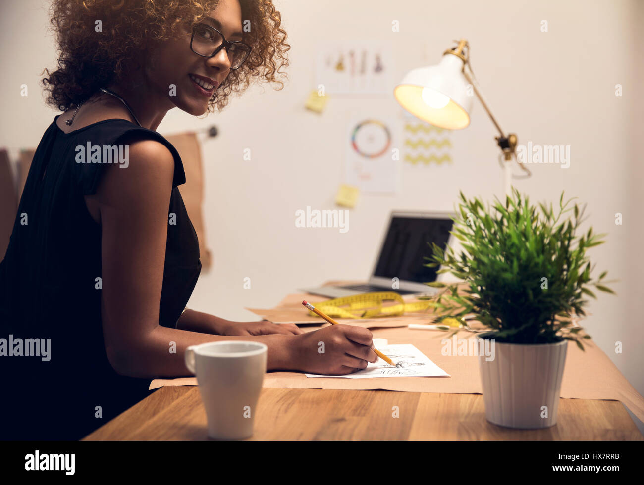 A young fashion designer working on her atelier Stock Photo - Alamy