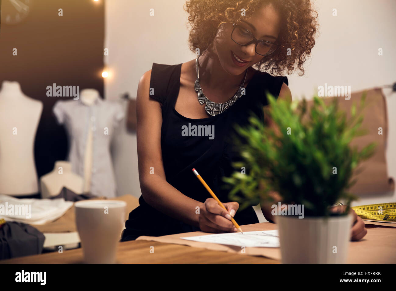 A young fashion designer working on her atelier Stock Photo - Alamy