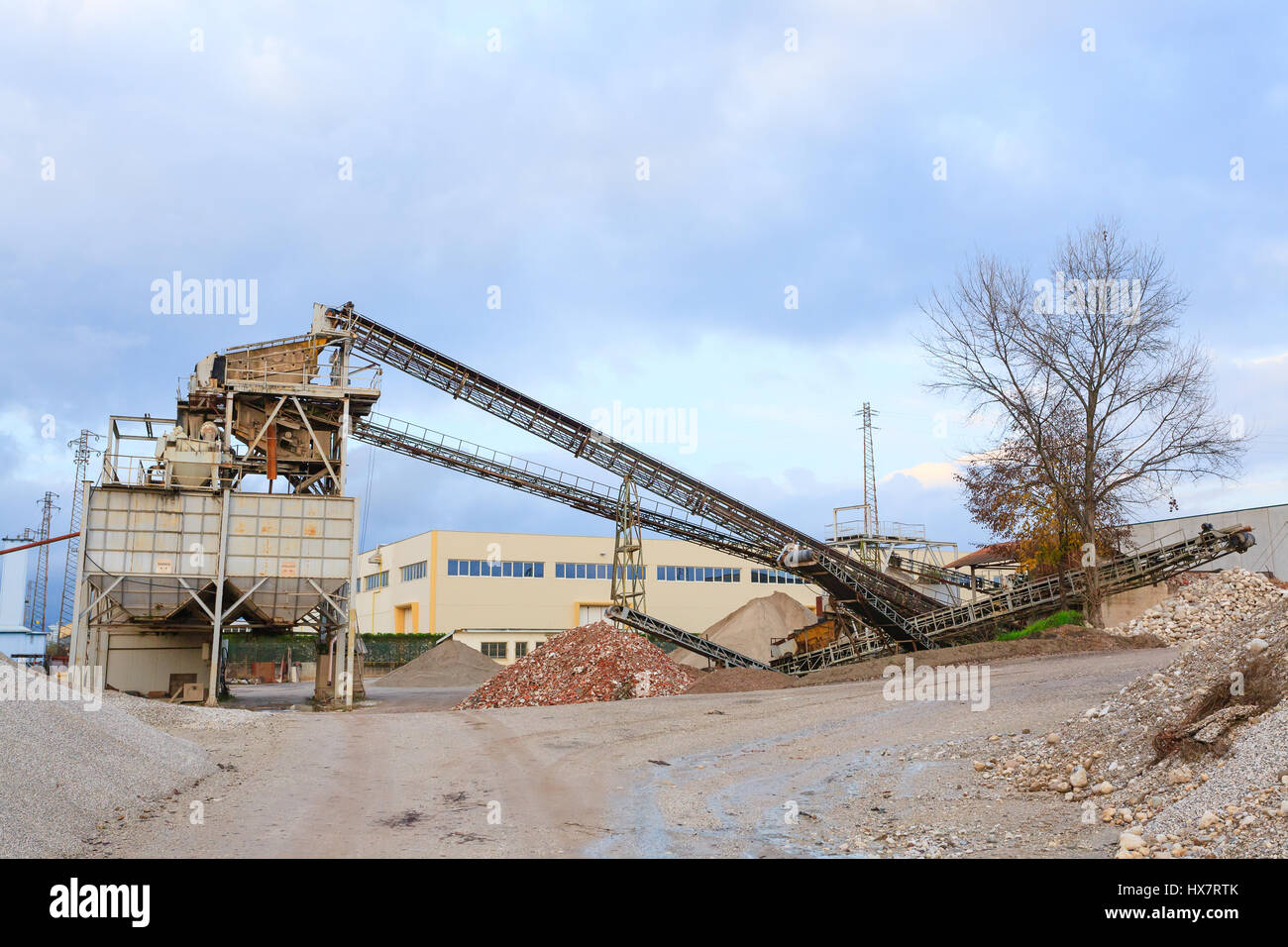 Stone quarry with silos and conveyor belts. Industrial equipment