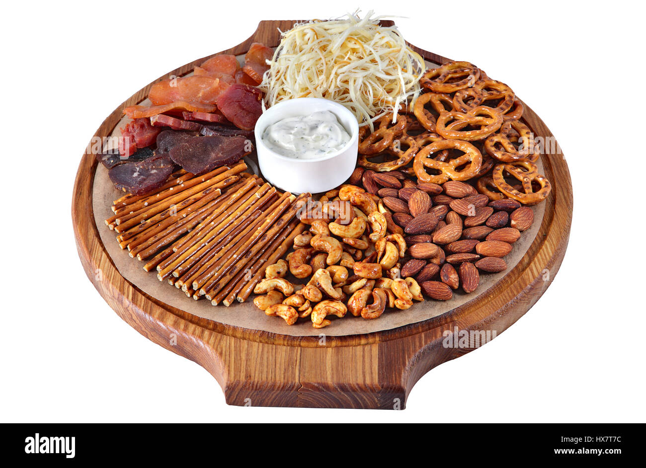 Cocktail of beer snacks on round wooden board with handles, cheese