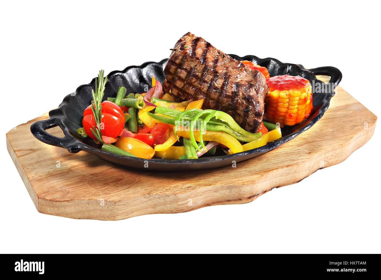 https://c8.alamy.com/comp/HX7TAM/mexican-steak-in-cast-iron-oval-serving-dish-with-handles-on-a-wooden-HX7TAM.jpg