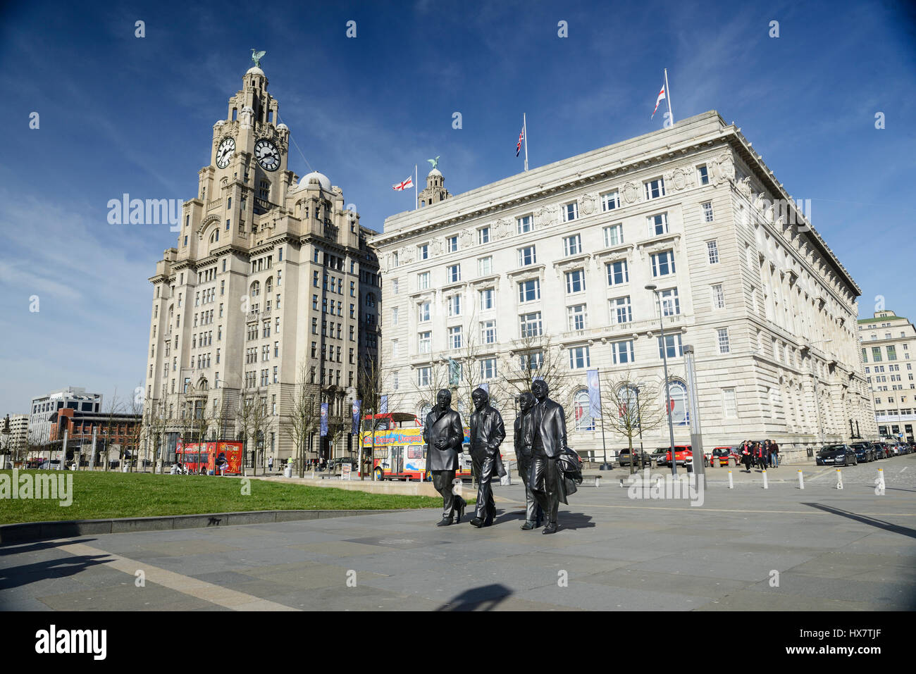 Statues of the famous Liverpool Group The Beatles situated in front of the iconic buildings at