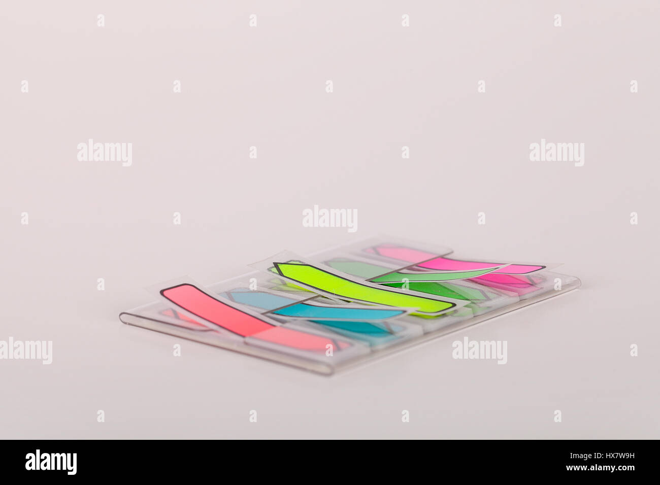Colorful arrow sticky tabs on a white surface post it tabs isolated on