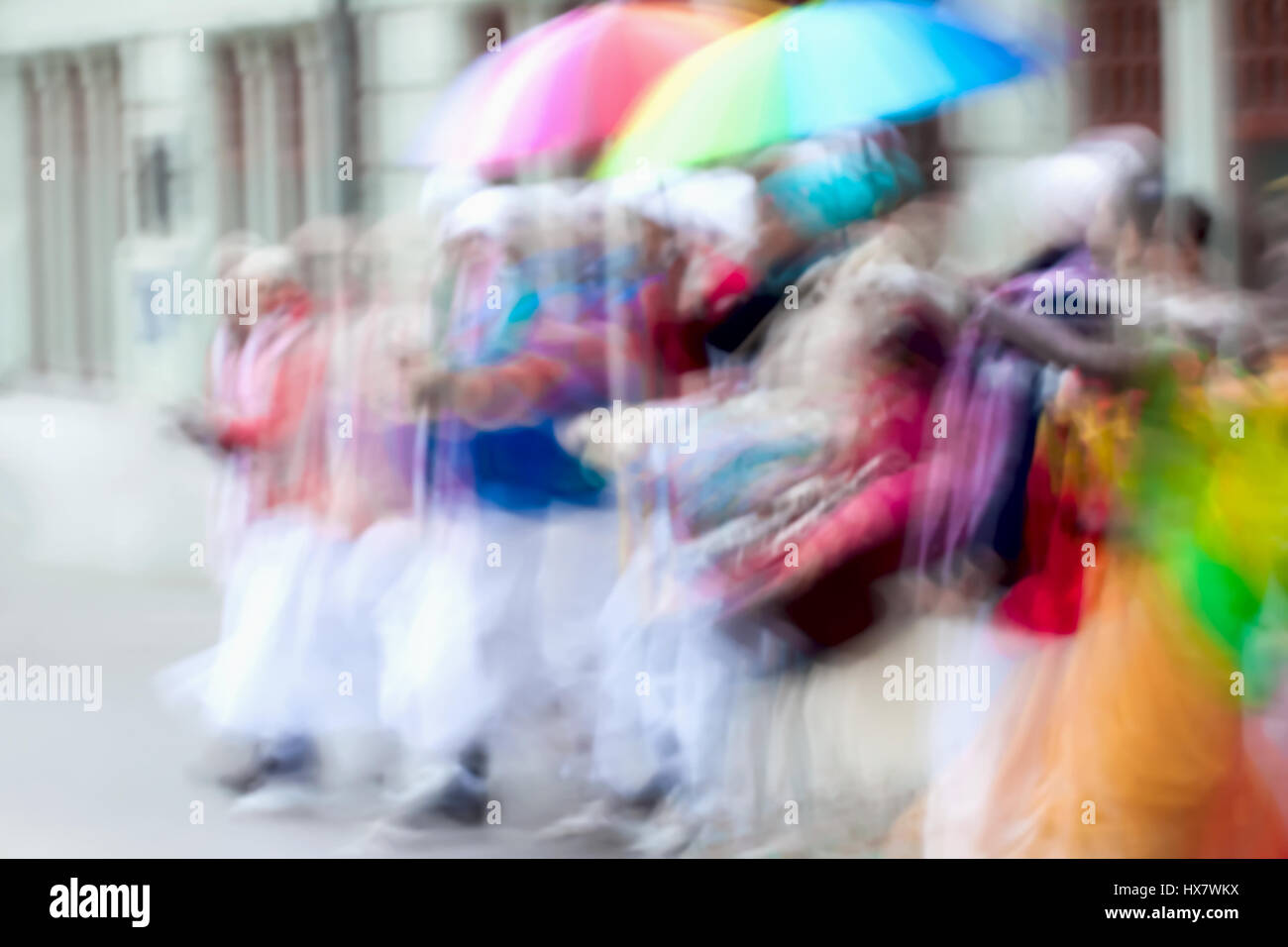 Abstract defocused motion blurred People group of Hare Krishna movement singing and dancing in the streets of the city with the words Hare Krishna Stock Photo