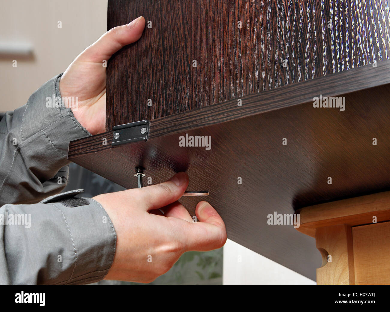 Assembling of furniture with a hexagon furniture key in hand of the