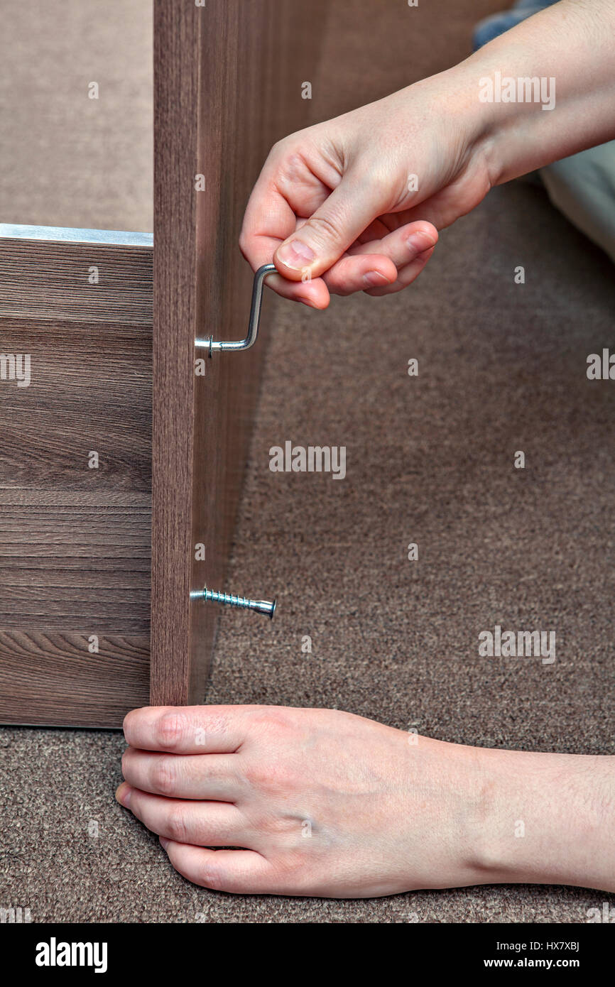 Joiner furniture assemblage at home using allen key, hexagonal wrench