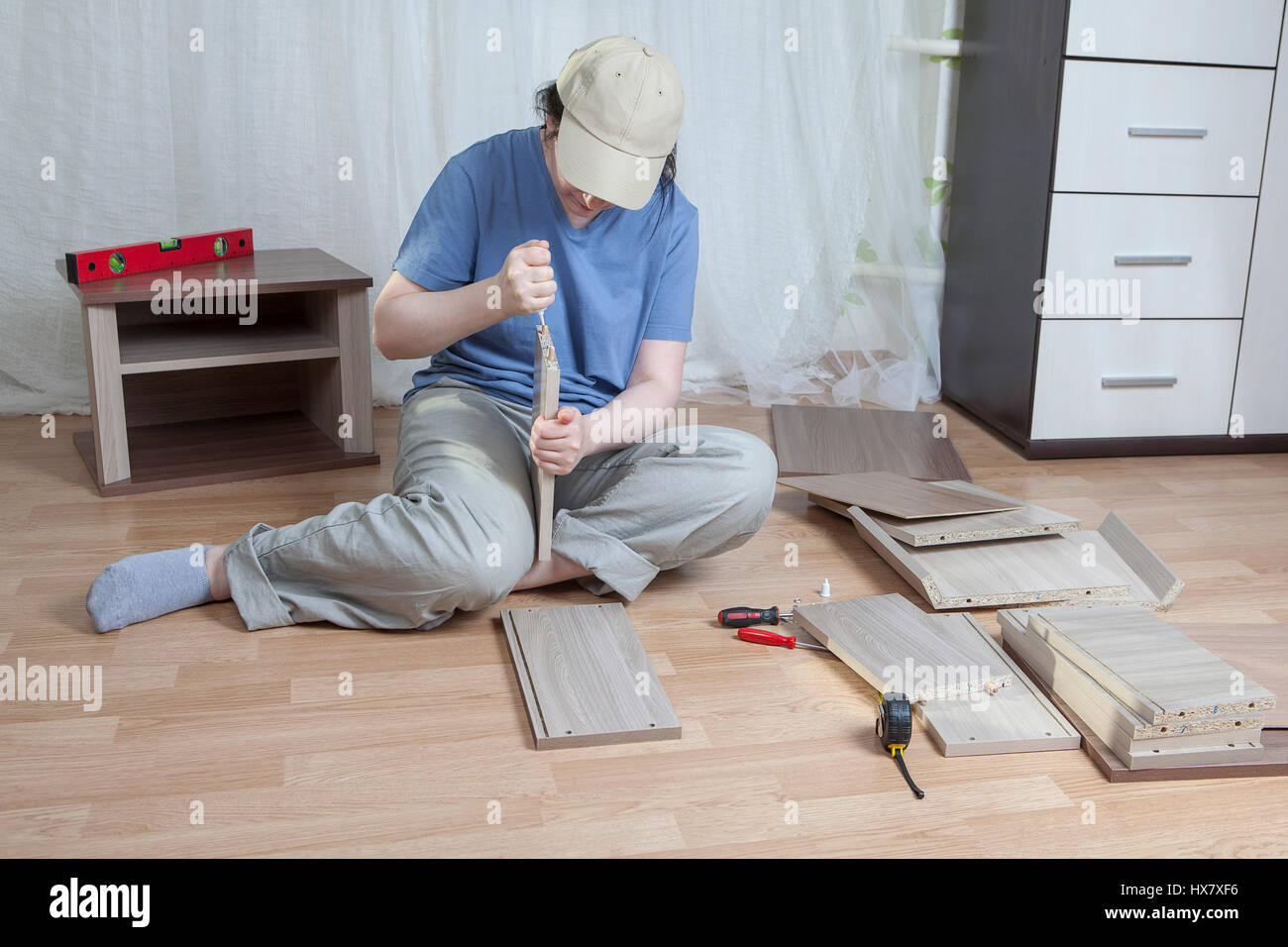 Assemble wooden furniture, woman putting together self assembly