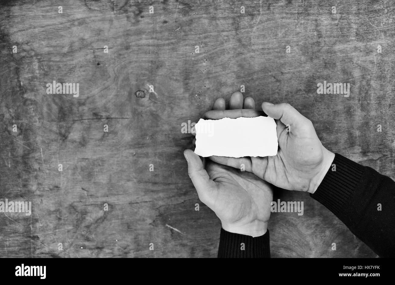 monochrome photo male hands holding a white blank sheet of paper Stock ...