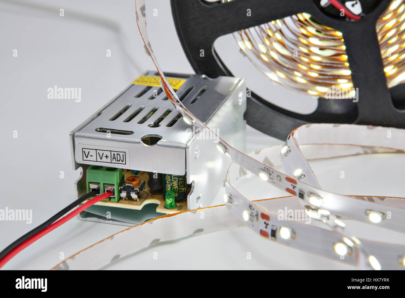 Lighted diodes on reel LED tape, and voltage converter Stock Photo Alamy