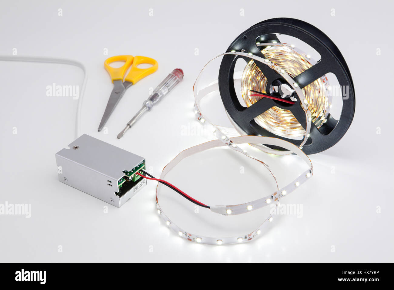 Roll tape and shining LED voltage converter. Stock Photo