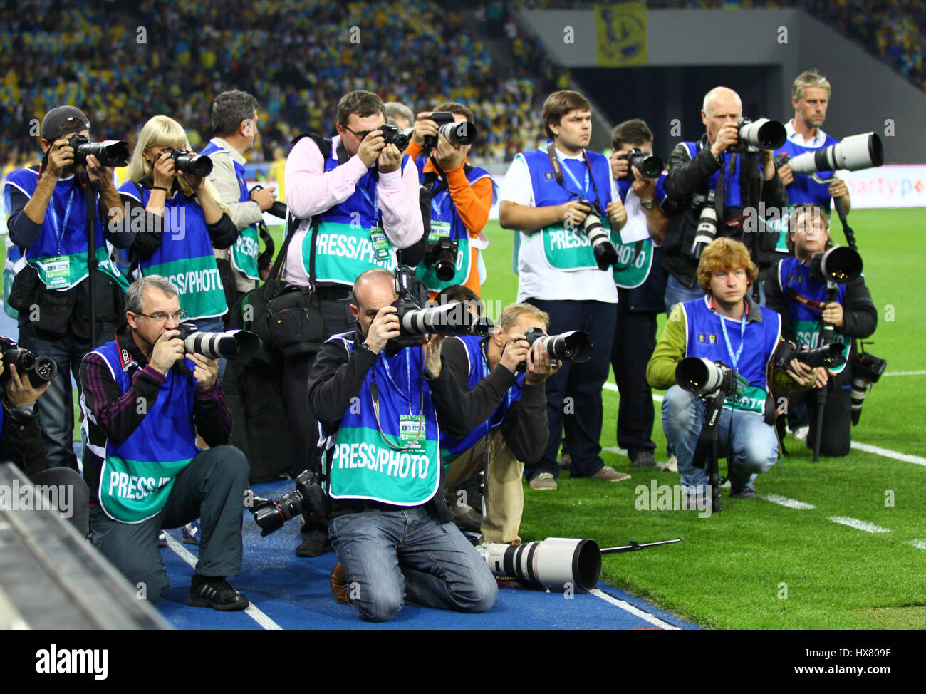 KYIV, UKRAINE - SEPTEMBER 10, 2013: Crowd of sports photographers before FIFA World Cup 2014 qualifier game Ukraine vs England at NSC Olympic stadium  Stock Photo