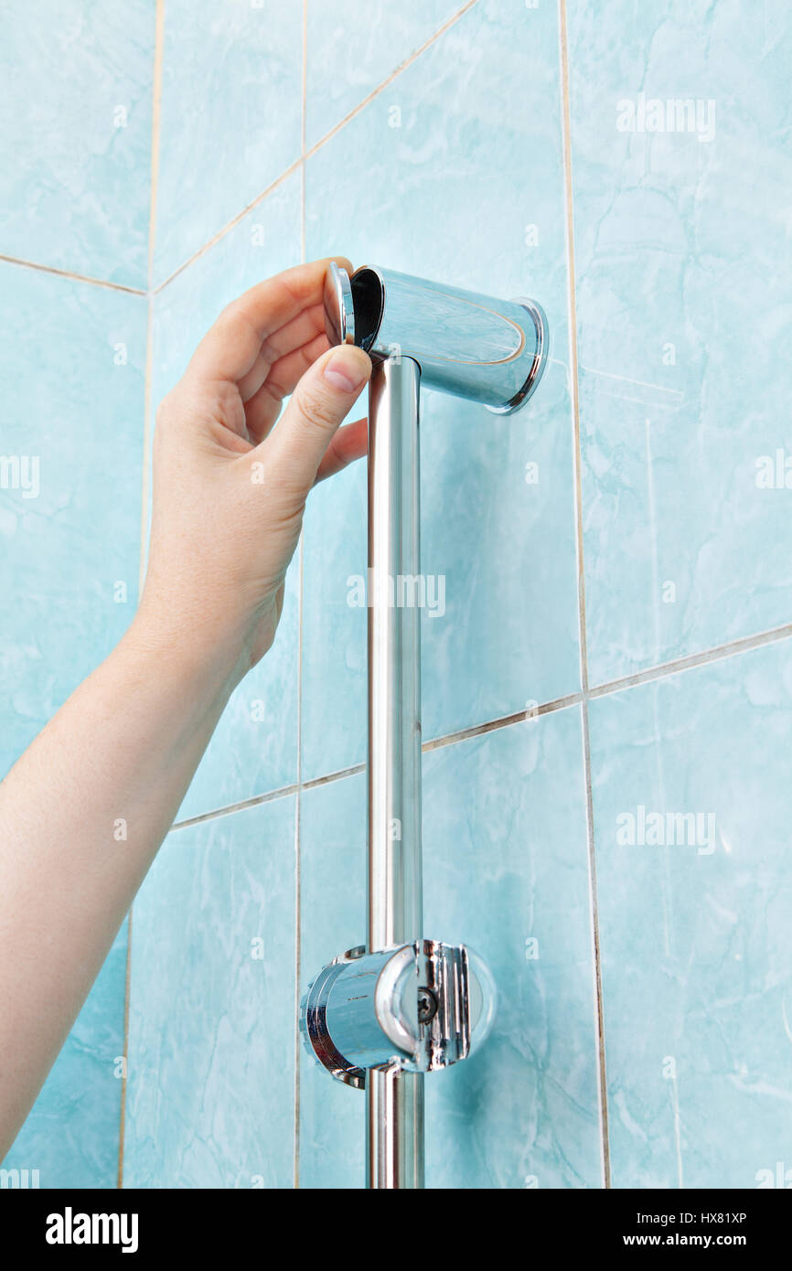 Replace wall mounted vertical shower holder, remove the cover bracket slide  rail bar Stock Photo - Alamy