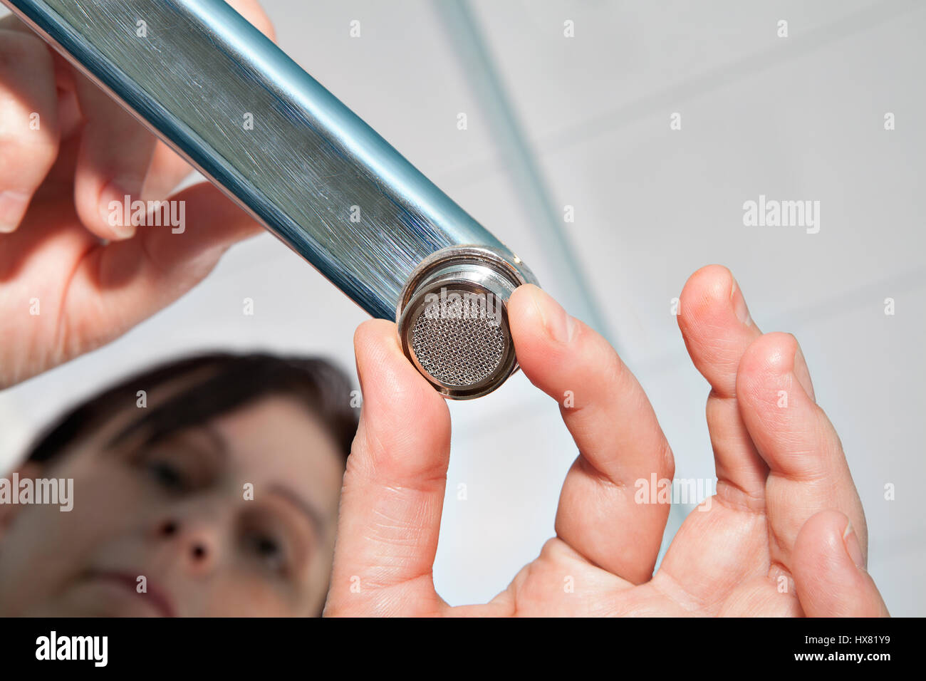 Woman handyman replace tap aerator, install new faucet aerator, hands