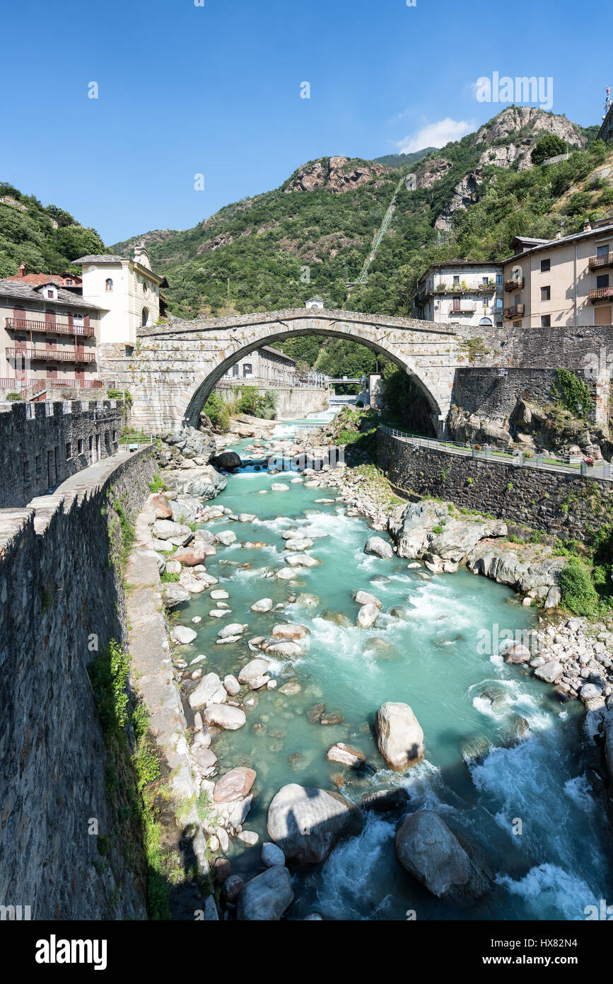 Turquoise river and old stone bridge in Pont-Saint-Martin, Aosta valley, North Italy, Alps, Europe, EU Stock Photo
