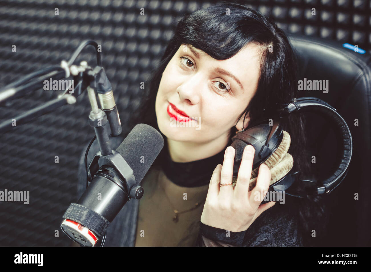 Female reporter doing a survey with microphone and clipboard Stock Photo