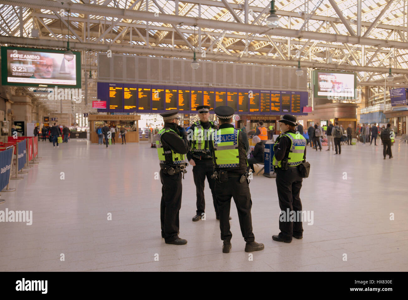 central station Glasgow interior police huddle terrorism police central station British transport police Stock Photo