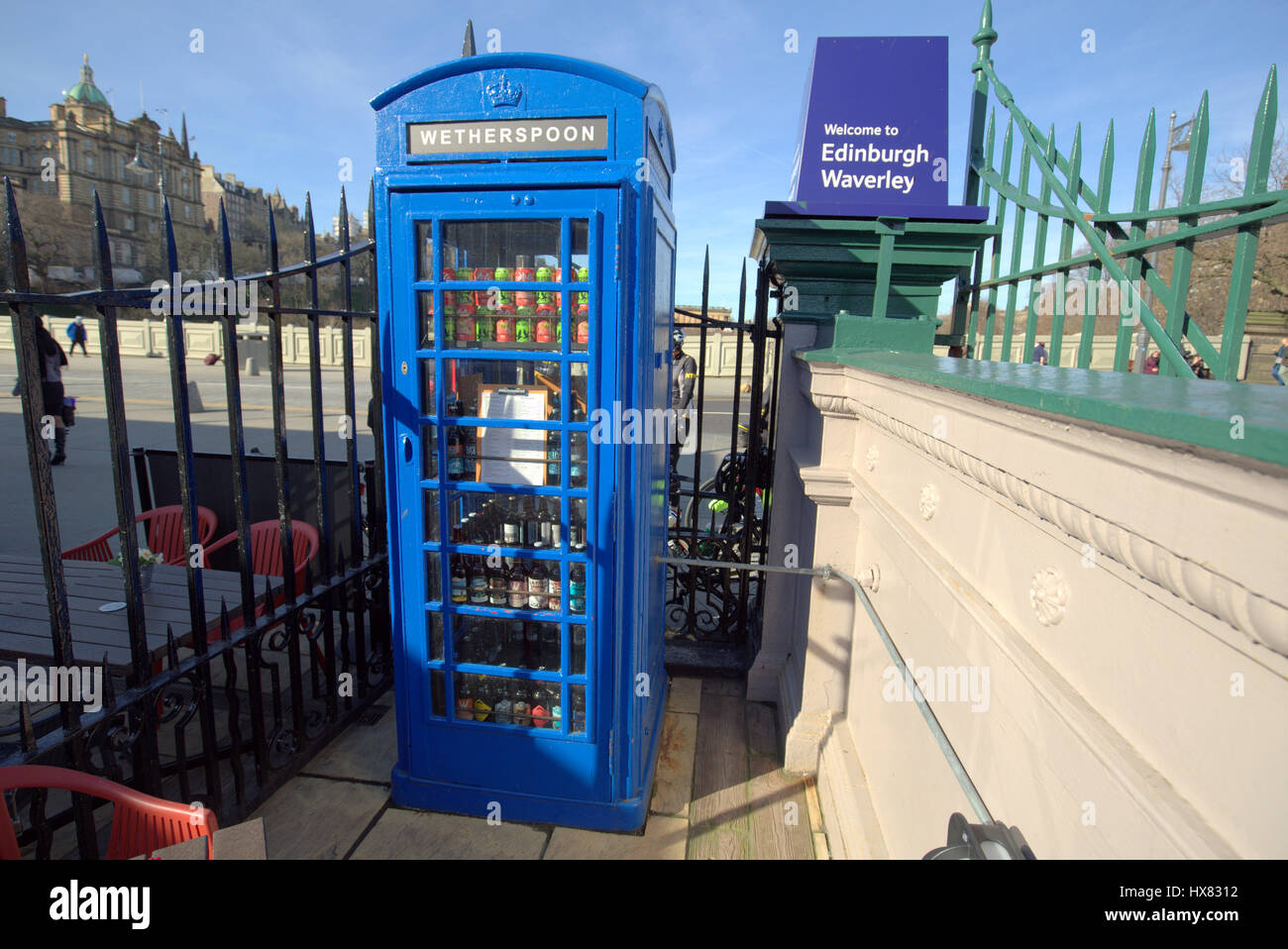 blue telephone box converted to fridge in pub courtyard waverley rail station Edinburgh Wetherspoons Stock Photo