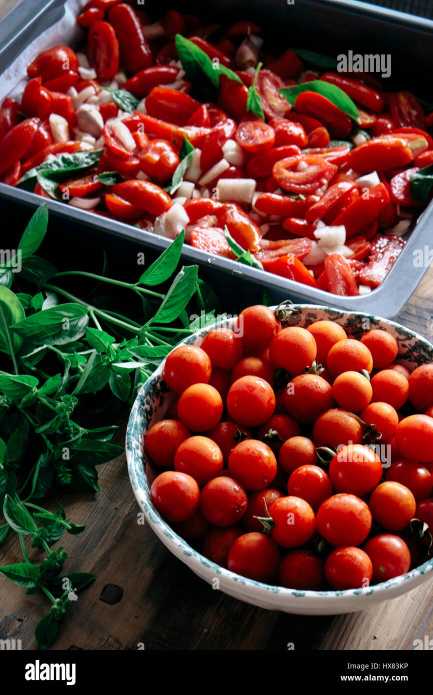Cooking italian tomato sauce with fresh tomattoes, basil and onion Stock Photo