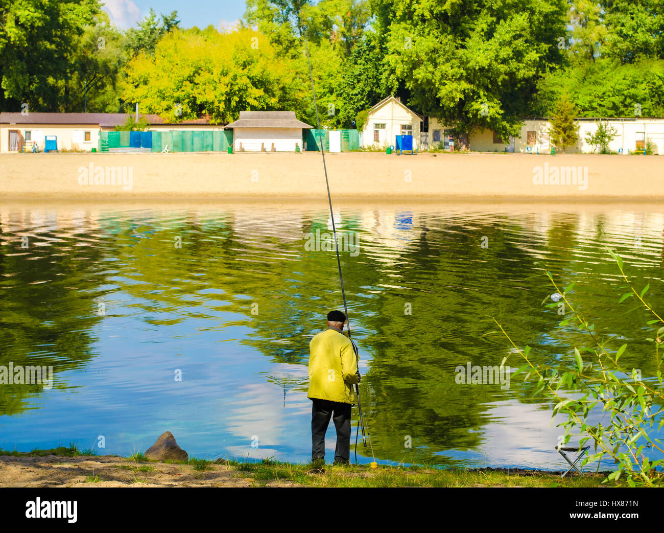Old man fishing on river bank hi-res stock photography and images