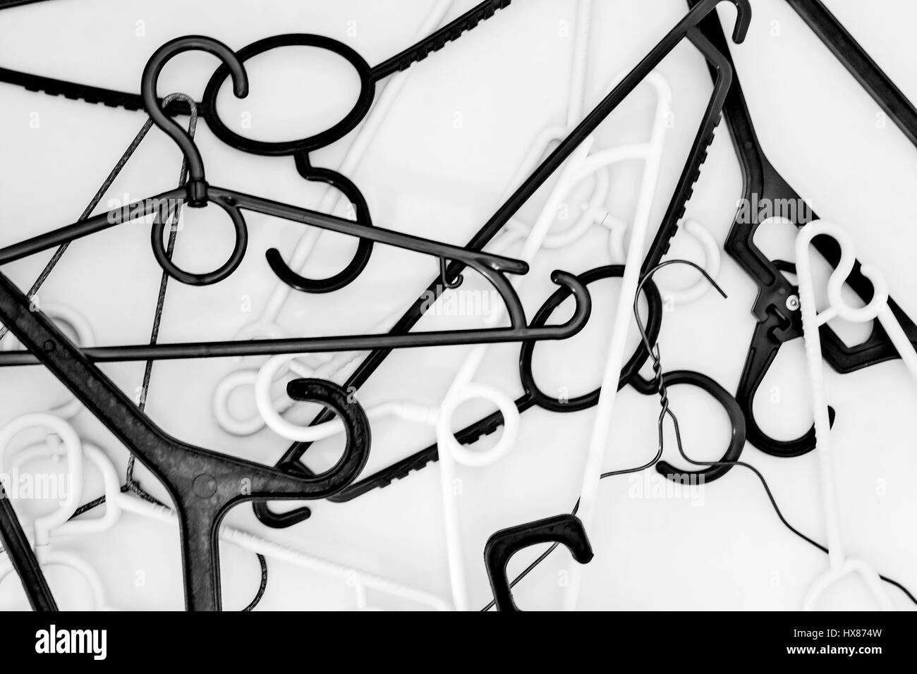 Many hangers of different shapes and colors, top view, white background. Stock Photo