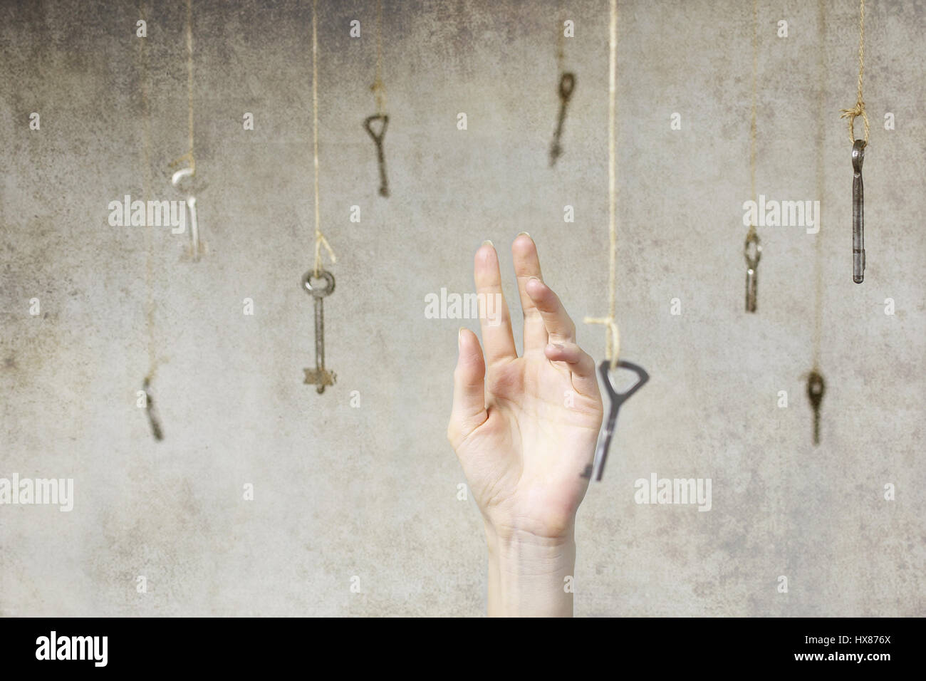 hand stretching for one of the many old vintage keys Stock Photo - Alamy