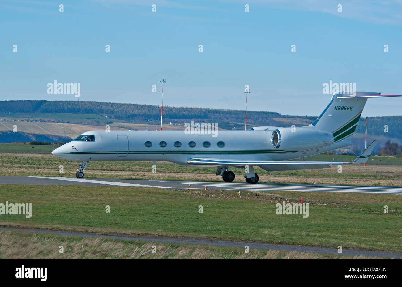 Large Business Jet Gulfstream GV aArriving at Inverness Dalcross airport in the Scottish Highlands. Stock Photo