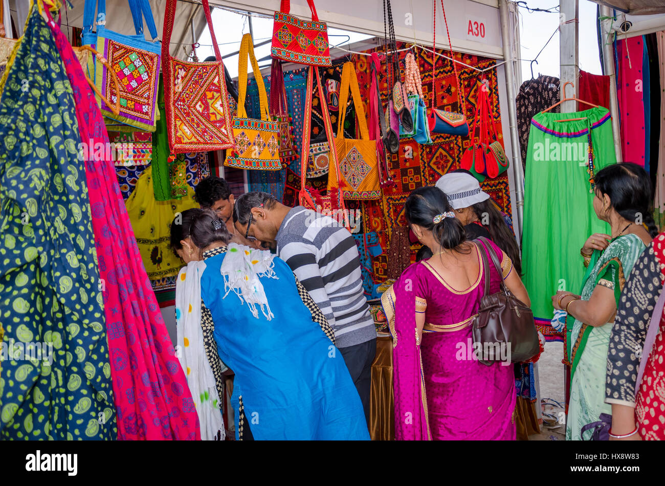 KUTCH, GUJARAT, INDIA - DECEMBER 27, 2016: An unidentified group of people at handicraft shop looking at colorful embroidery items. Stock Photo