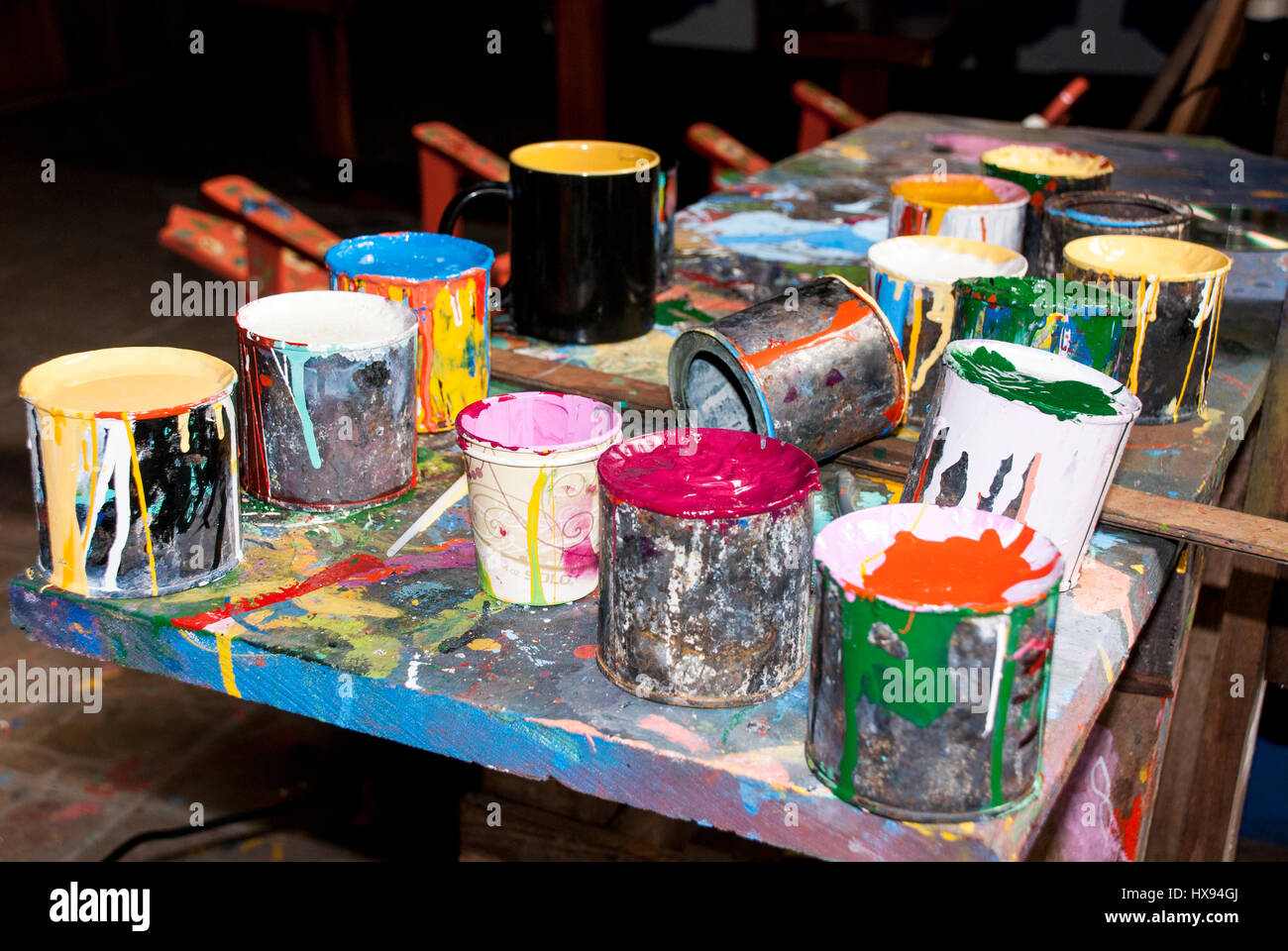 Paint bottles, brushes and paint cans in an art studio Stock Photo Alamy