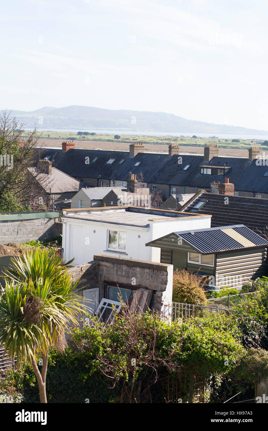 A view looking over back gardens, roofs of house, out to the ocean, Howth, Dublin Bay, Clontarf, Ireland Stock Photo