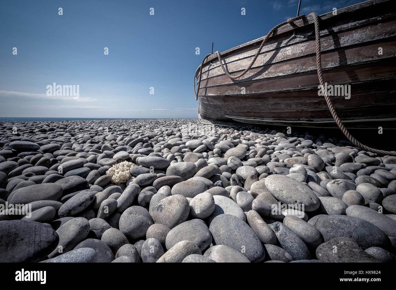 Chesil Beach, Dorset, pebbles with boat Stock Photo Alamy