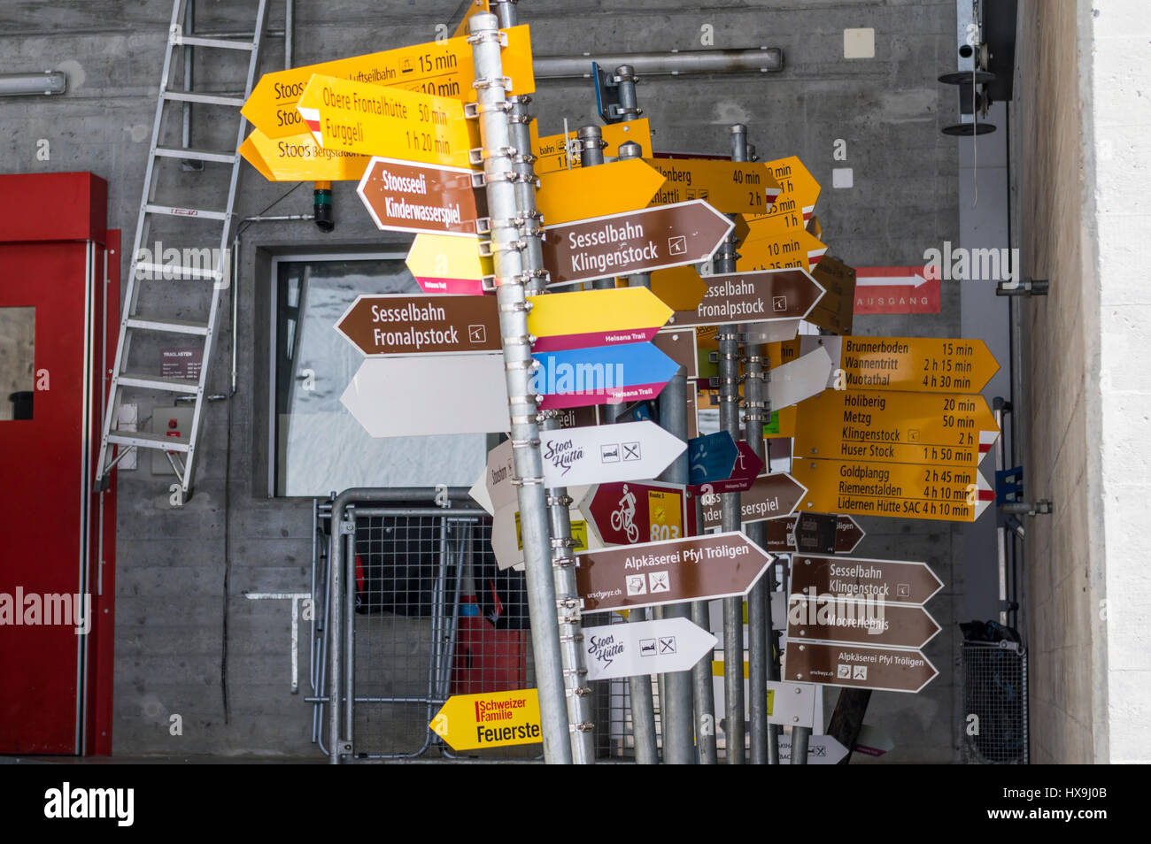 Many Swiss hiking signposts with overlapping signs stored for later reuse. Stock Photo