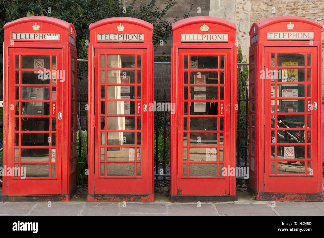 Four old red telephone boxes Stock Photo