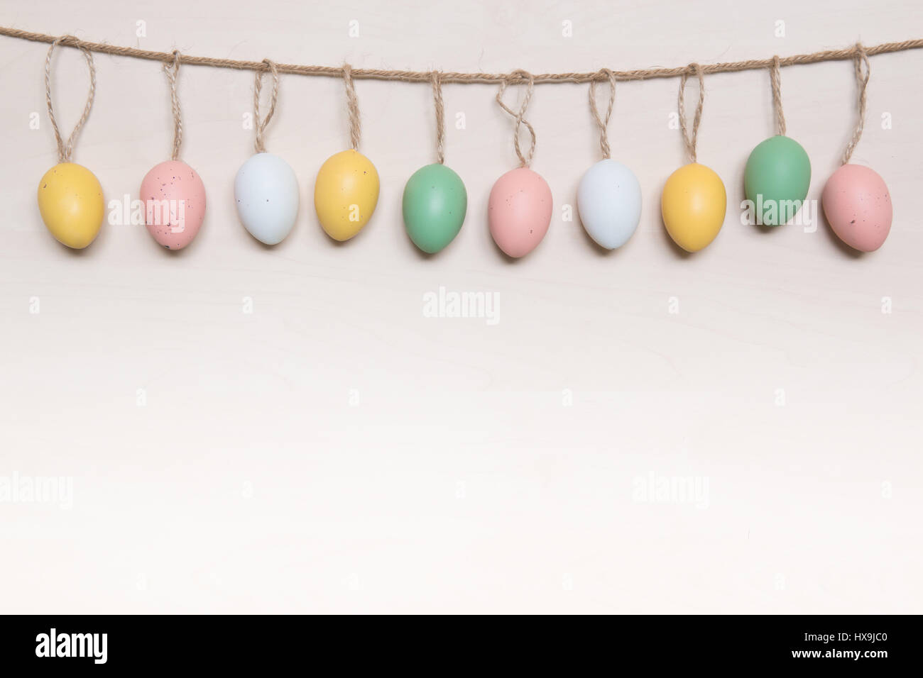 Easter Rope Colorful Easter eggs hanging on rope over wooden background Stock Photo ...
