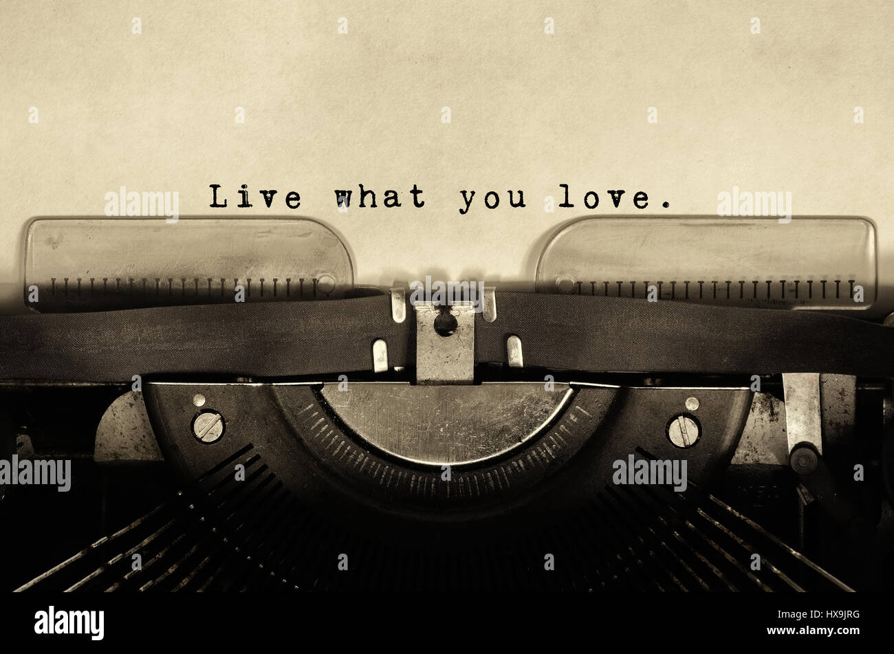 Live what you love Inspirational quotes type on vintage typewriter. Stock Photo