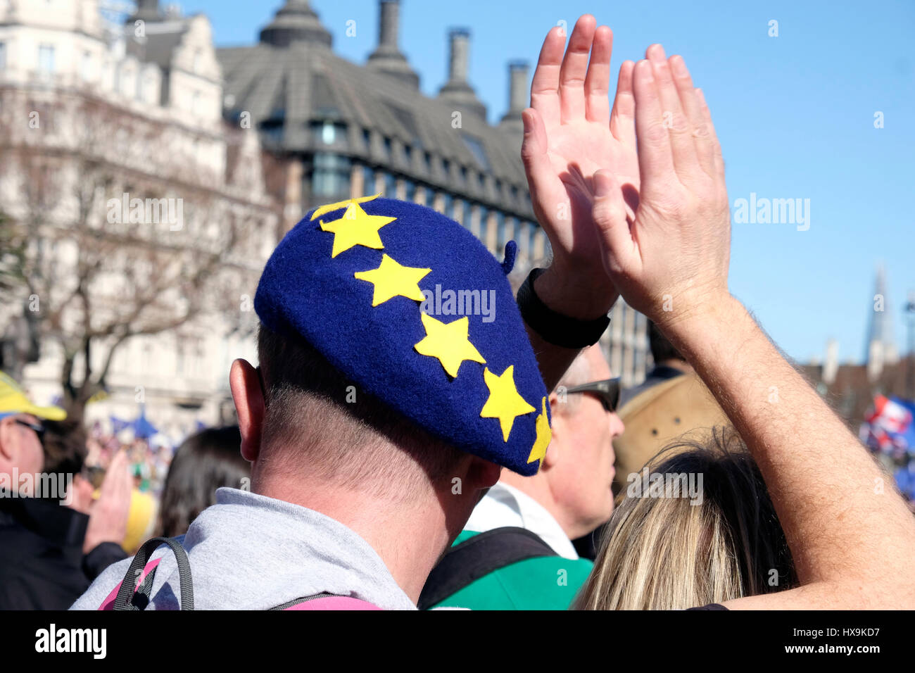A rear view of a man wearing an EU beret, claps during a protest against Brexit, Westminster, London. Stock Photo