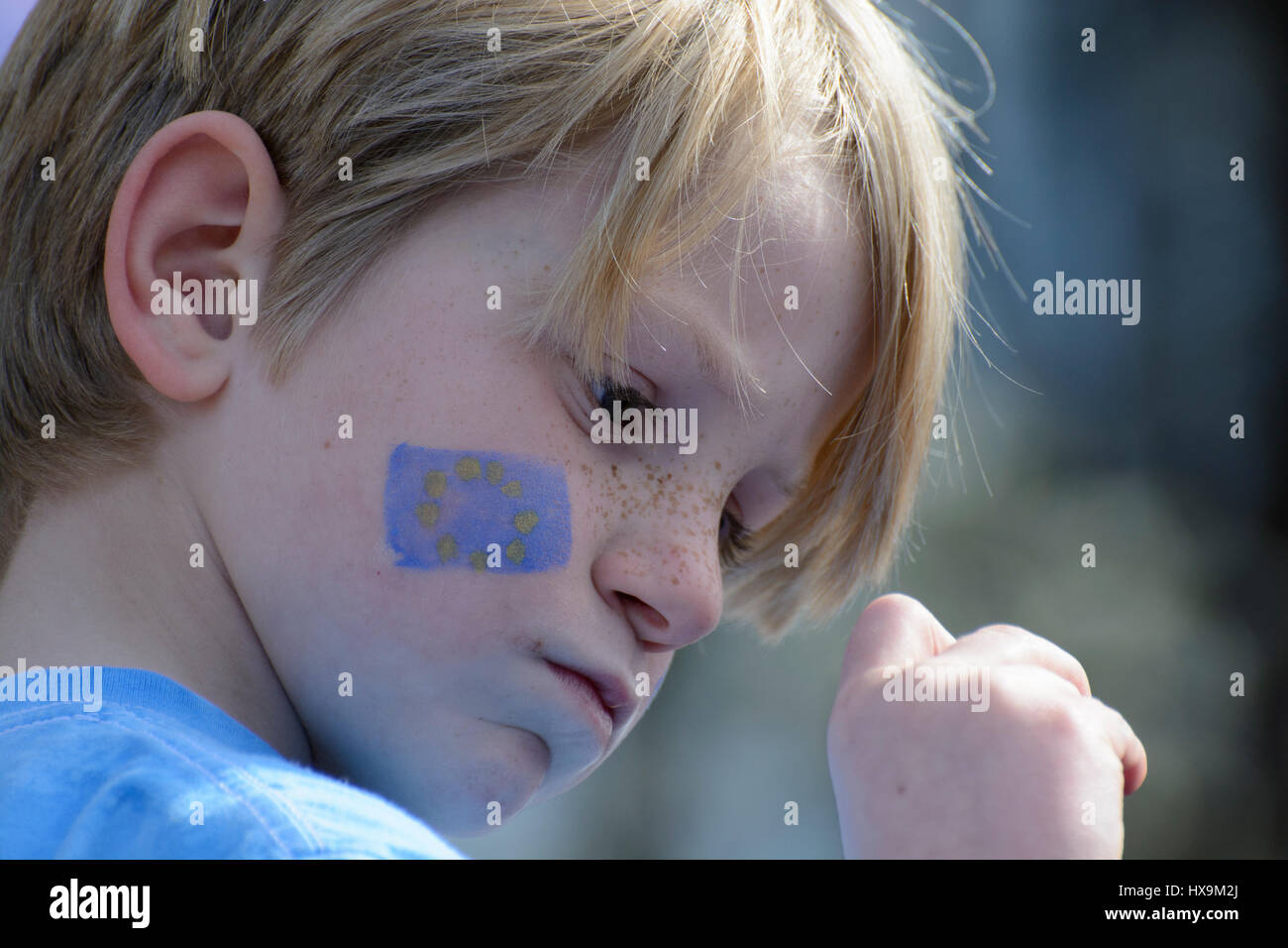 London, UK. 25th Mar 2017. Portrait of a child anti-brexit protester with a blue EU flag drawn over the cheek. The young boy was amongst the thousands of protesters who participated in the Unite for Europe march in London. Credit: ZEN - Zaneta Razaite/Alamy Live News Stock Photo
